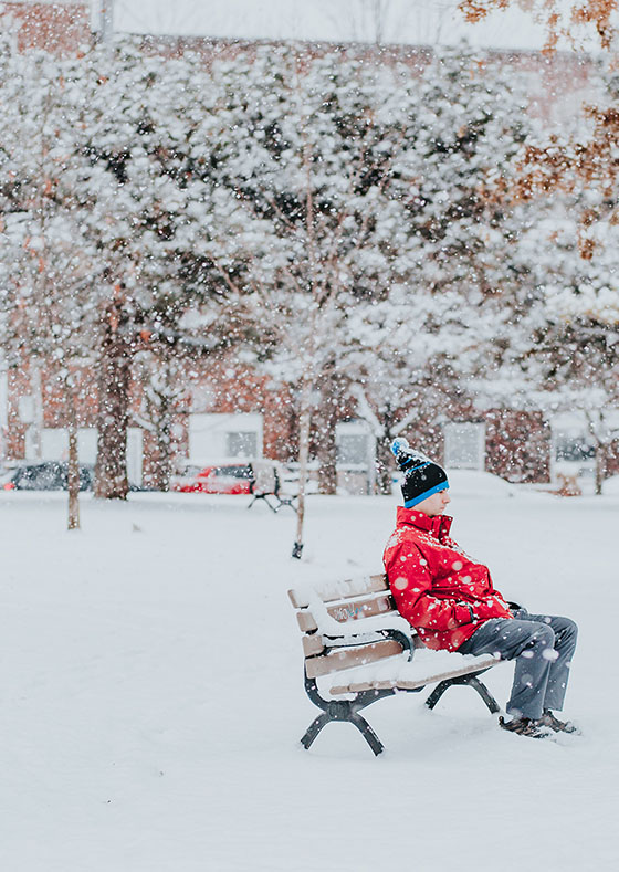 Person SItting Outside in a Snow Storm