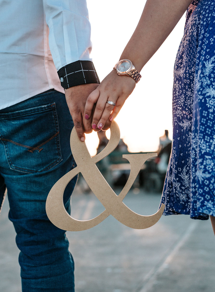 Couple Holding the & Symbol Couple Holding the & Symbol