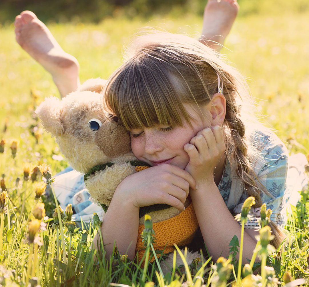 Girl Smiling and Holding Her Stuff Bear Girl Smiling and Holding Her Stuff Bear