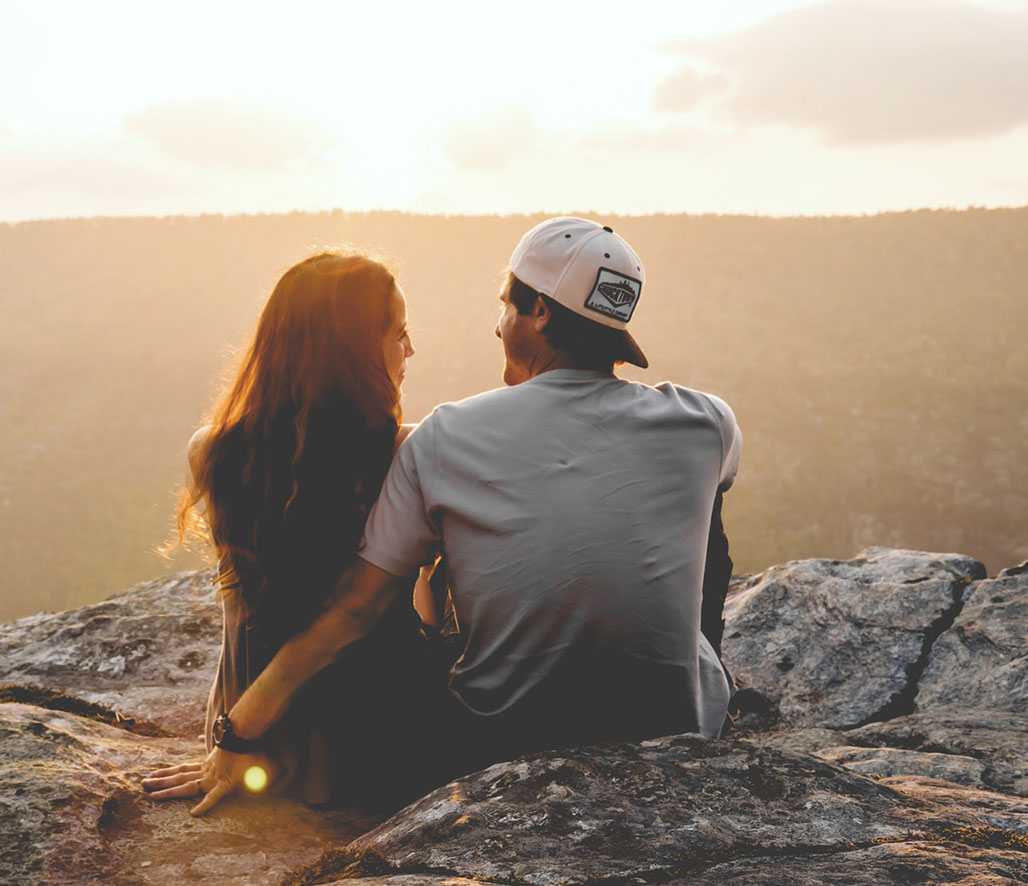 Young Couple Enjoying the View of the Mountains Young Couple Enjoying the View of the Mountains