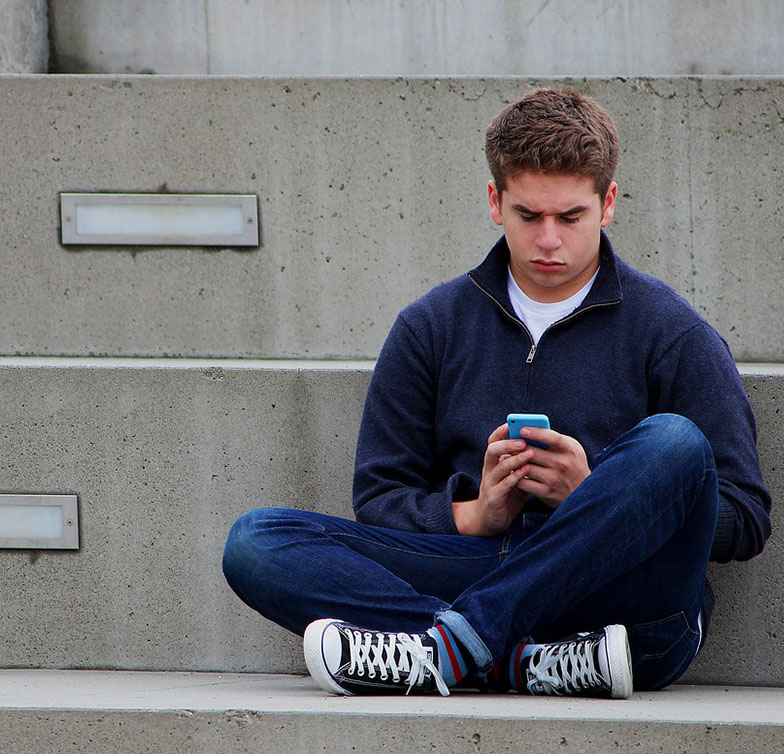 Teenage Texting on His Phone Teenage Texting on His Phone