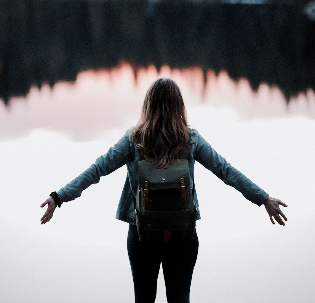 Woman Standing in Front of a Lake Woman Standing in Front of a Lake