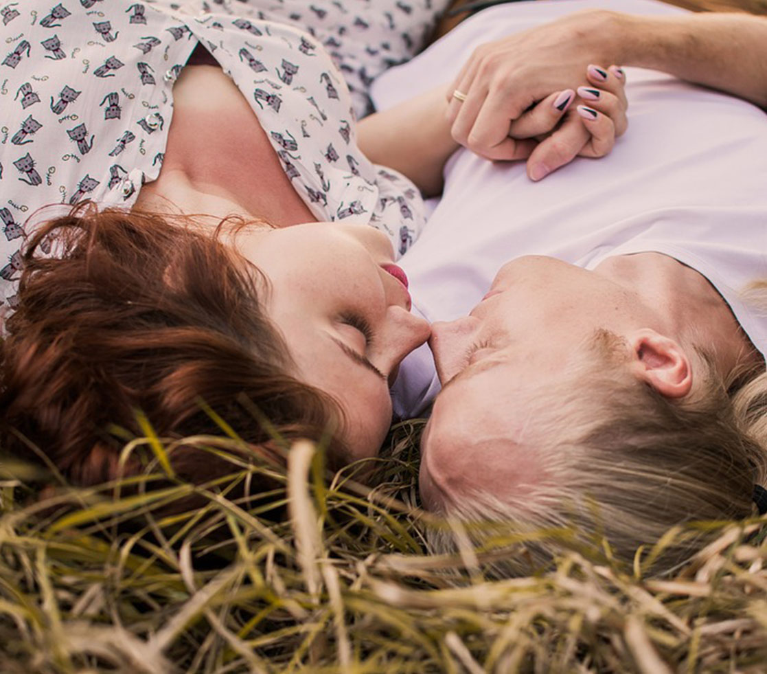 COuple Laying In The Grass and Holding Each Others Hands COuple Laying In The Grass and Holding Each Others Hands