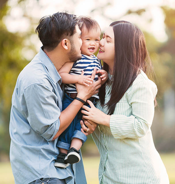 Family Holding Their Child Family Holding Their Child